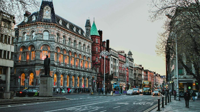 a city street with a clock tower in the middle of it